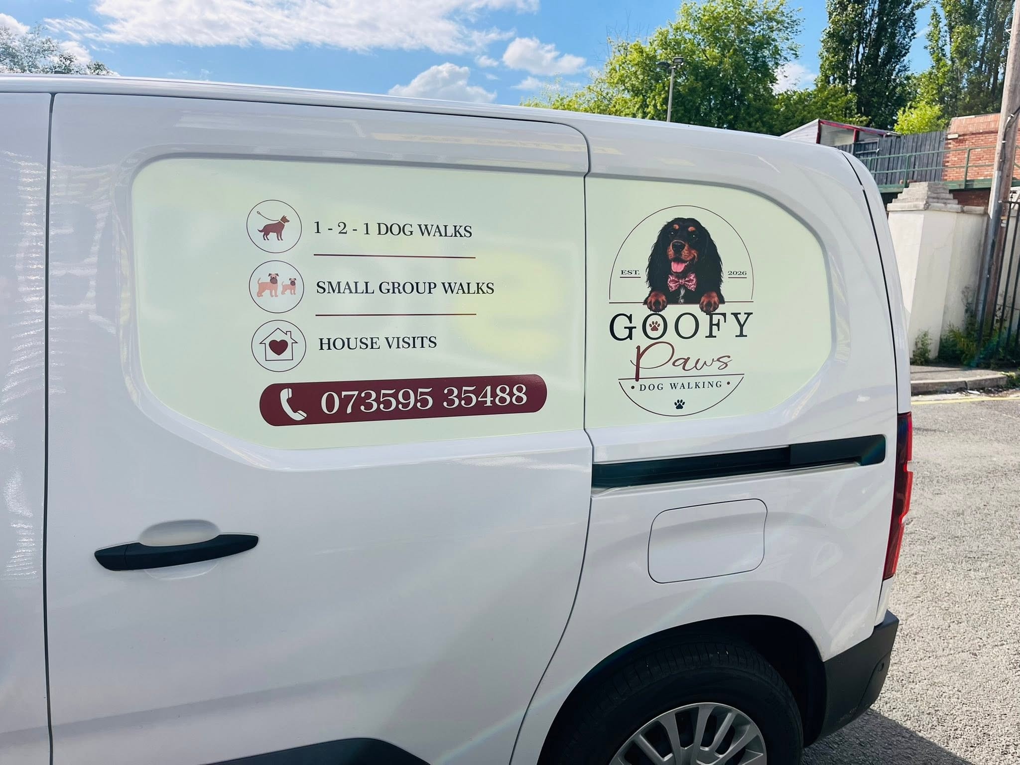 Goofy Paws branded van showing services and contact number